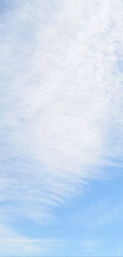 A peaceful blue sky with fluffy white clouds, perfect for a mobile wallpaper background.