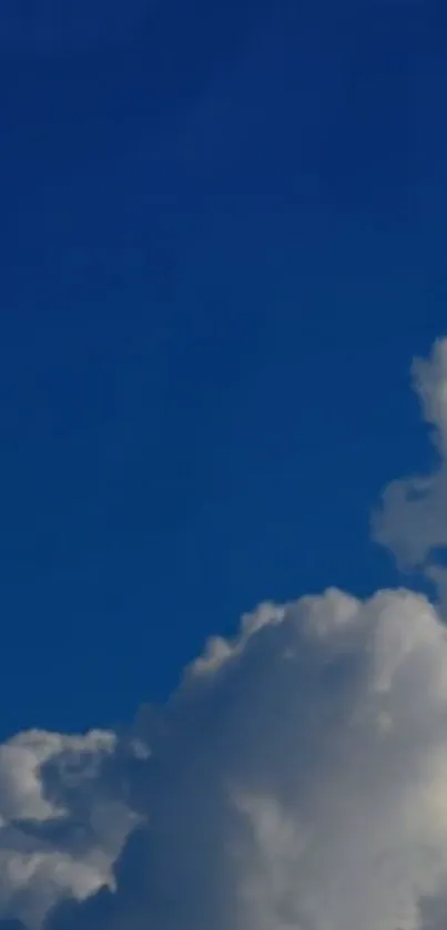 A calming view of a blue sky with fluffy white clouds.