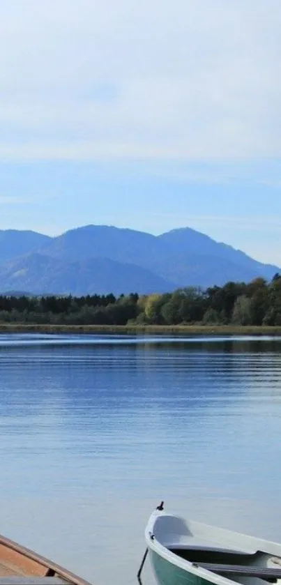 Serene lake with boats and mountains in the background.