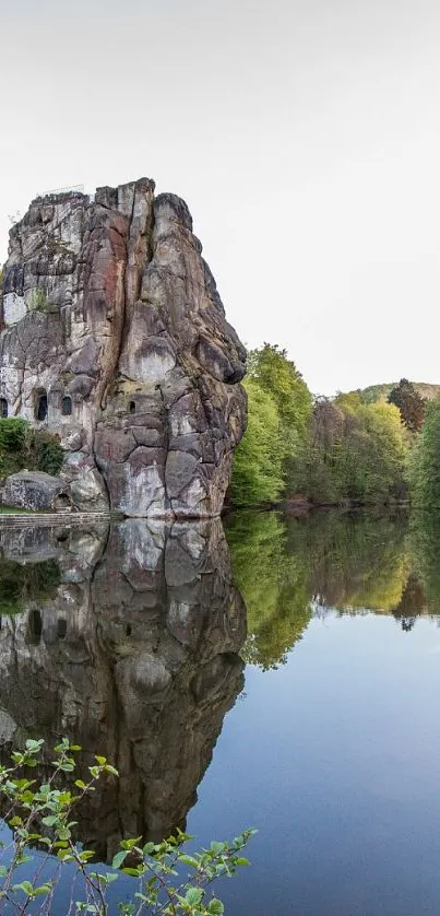 Serene lake reflecting rock formations and lush greenery.