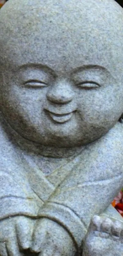 Stone monk statue with autumn leaves around.