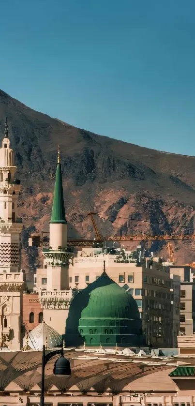 Mosque with a serene mountain backdrop on a sunny day.