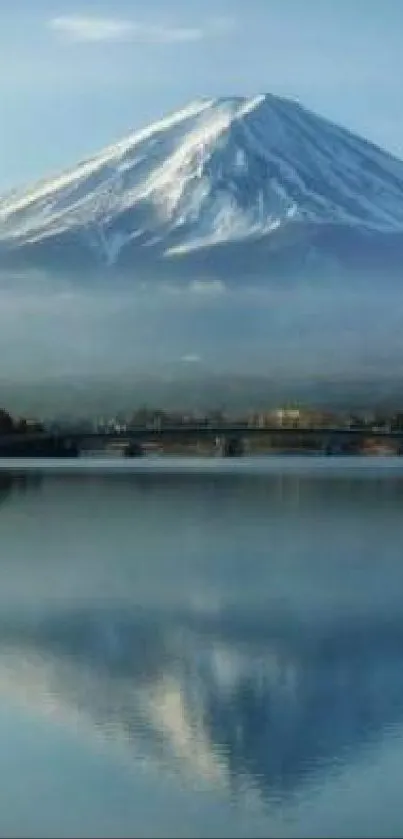 Majestic mountain with serene water reflection under blue sky.