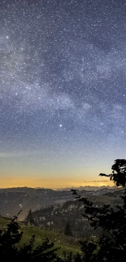 Serene night sky with stars over mountains and lush green landscape.