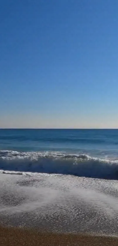 A serene wallpaper of ocean waves under a clear blue sky, perfect for calming your device.