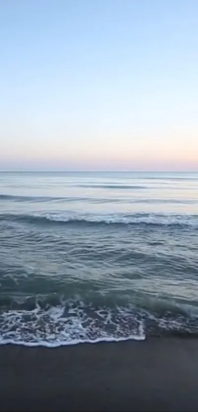 Serene ocean view with sunset horizon and calm waters.