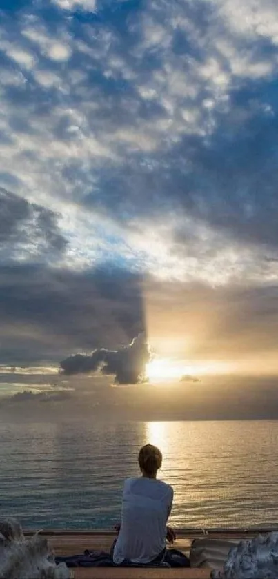 Person watching ocean sunset from the shore.