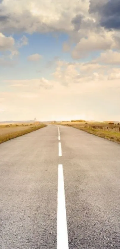 Serene road under a vast sky with clouds and horizon.