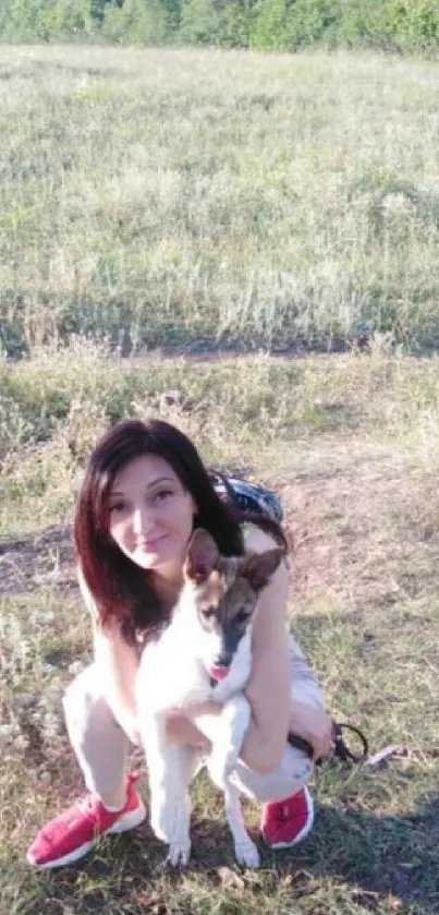 Woman and dog in a sunny meadow.