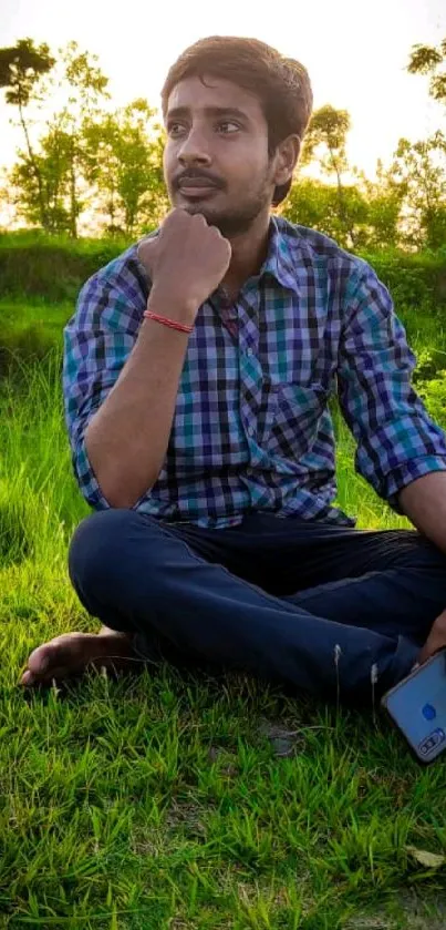 Man sitting in park during serene sunset.