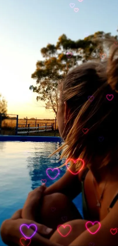 Woman by a pool at sunset, serene view.