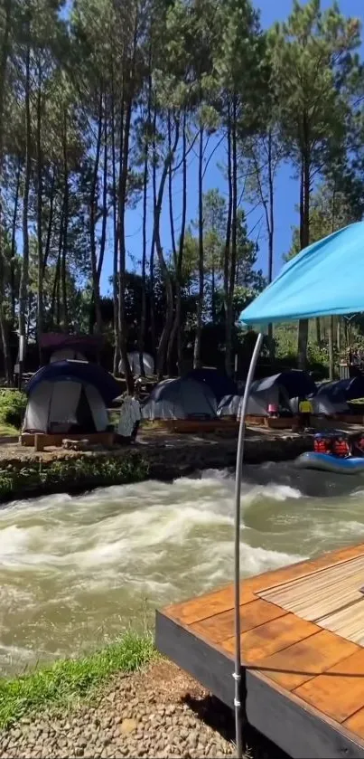 Riverside camping with tents and flowing water under a clear blue sky.