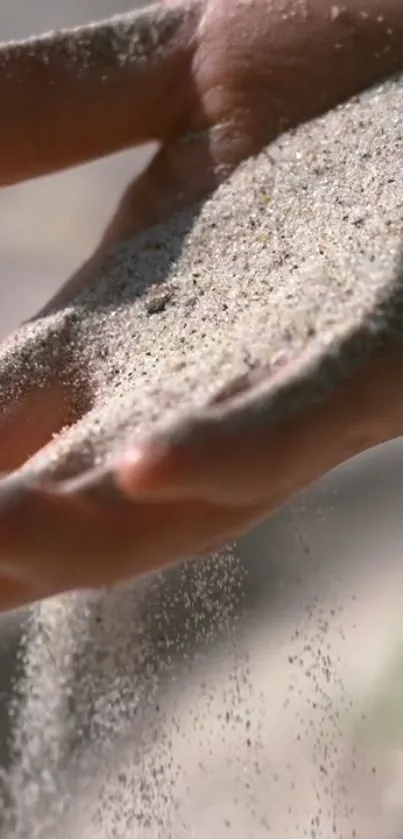 Hand gently holds sand in a calming flow.