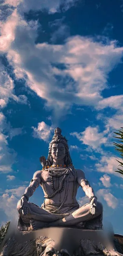 A serene statue sits under a vibrant blue sky.