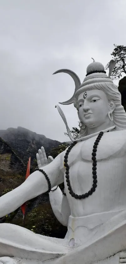 Serene Shiva statue with mountain background.