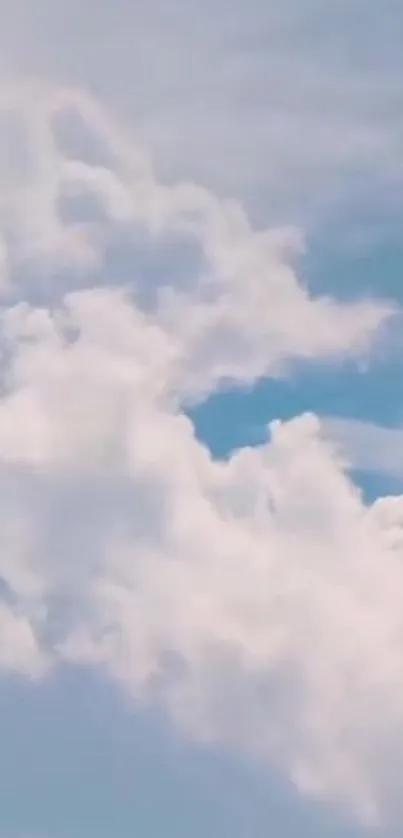 Fluffy white clouds against a blue sky wallpaper.