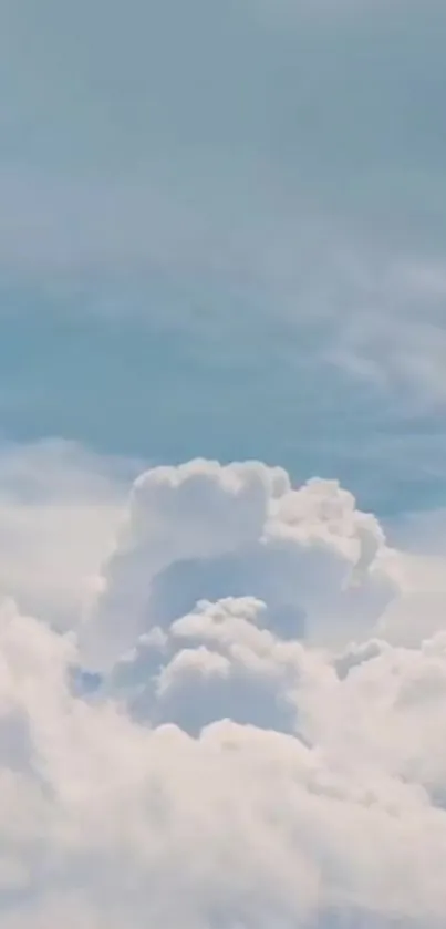 Tranquil sky with fluffy white clouds and soft blue tones.