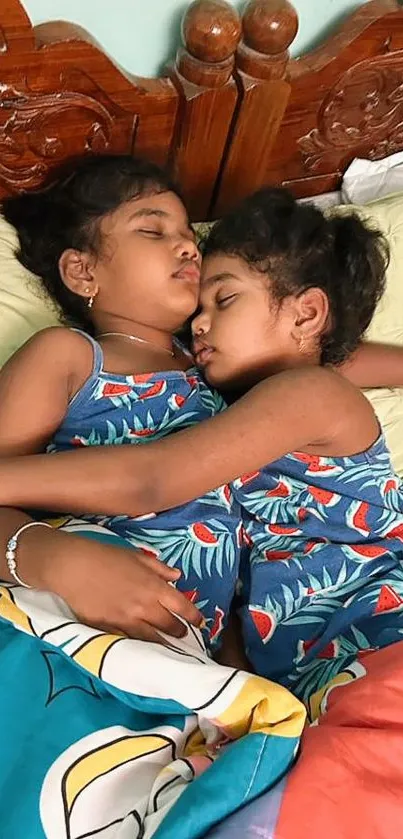 Two children sleeping peacefully in matching blue outfits on a cozy bed.