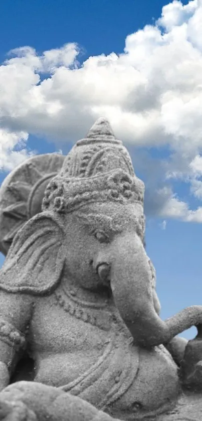 Stone elephant statue with blue sky and clouds background.