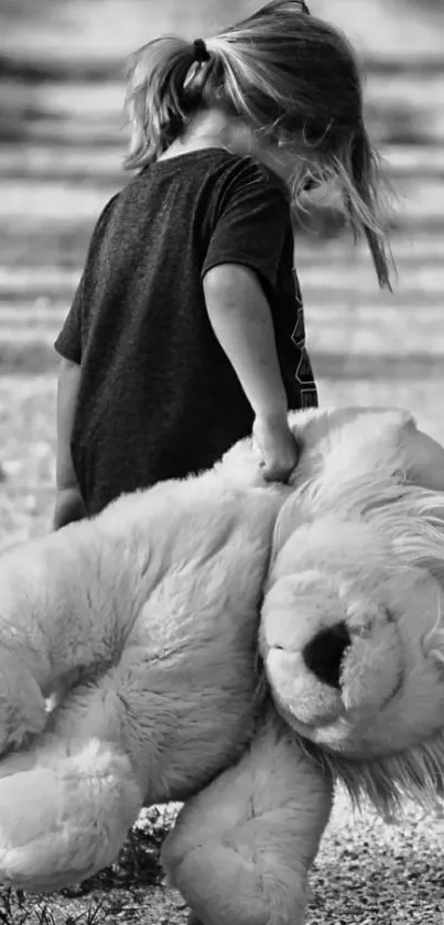 Child with teddy bear walking on path in grayscale image.