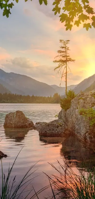 Serene sunset over mountains and lake with orange sky.