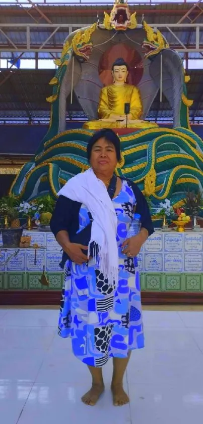 Woman standing before a temple statue.