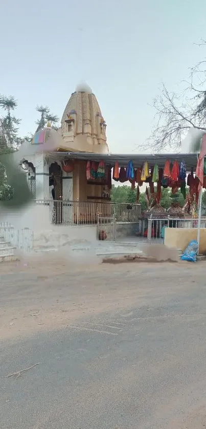 Serene temple with colorful flags and greenery.