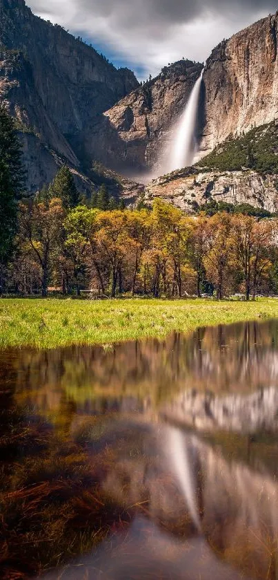 Serene waterfall with lush greenery and reflection in a tranquil pond.