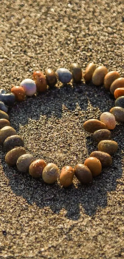 Heart-shaped pebbles on sandy beach background.