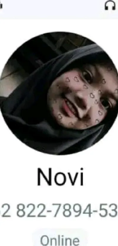 A personalized contact image with a smiling face displayed on a mobile phone screen.