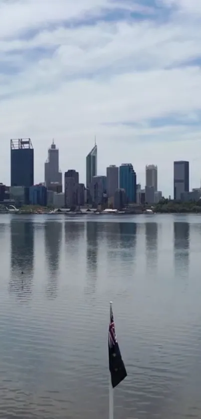 Perth city skyline with waterfront reflection under cloudy sky.