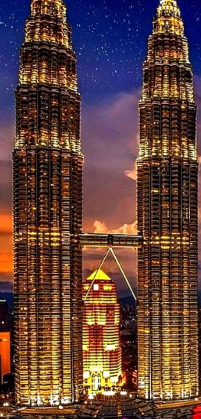 Petronas Towers illuminated against starry night sky.