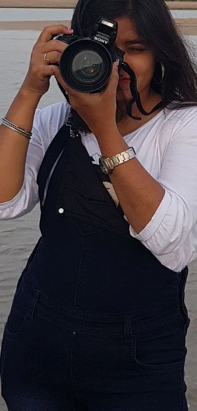 Woman capturing beach photography scene.