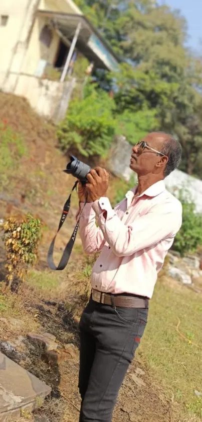 Photographer capturing nature's beauty outdoors.