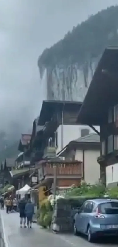 Charming village against a misty cliff backdrop.