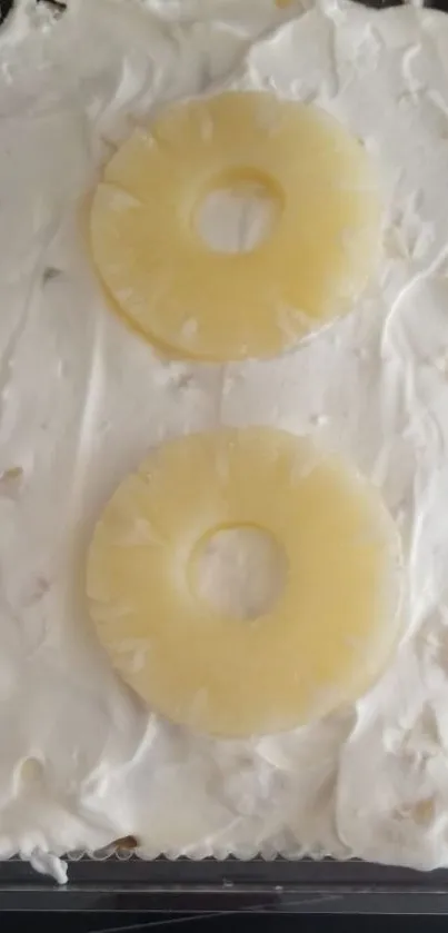 Creamy dessert with pineapple rings on top, perfect for food enthusiasts.