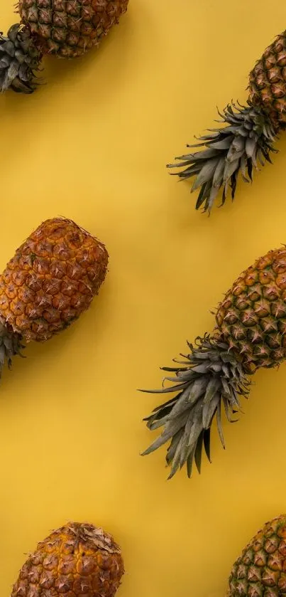 Yellow background with pineapples pattern wallpaper.