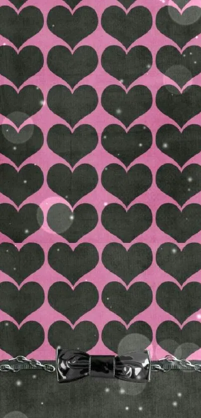 Pink and black heart pattern wallpaper with bow and chain accent.