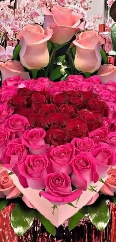 Heart-shaped pink and red rose arrangement with floral accents.