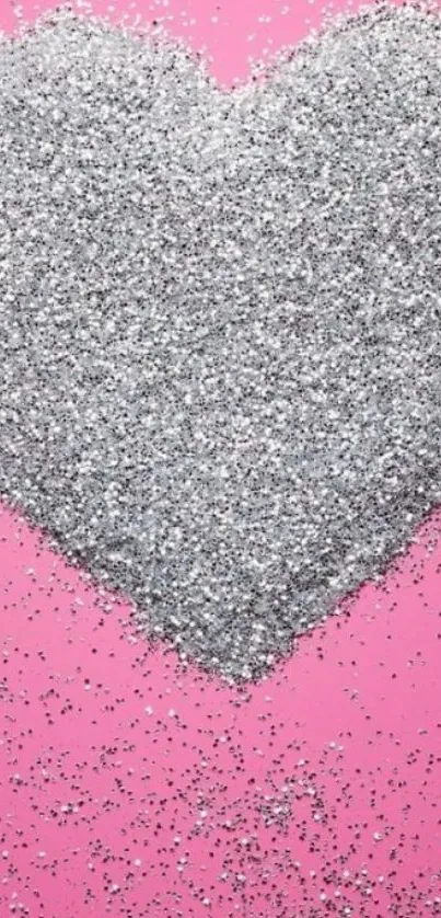 Mobile wallpaper with a silver glitter heart on a pink background.