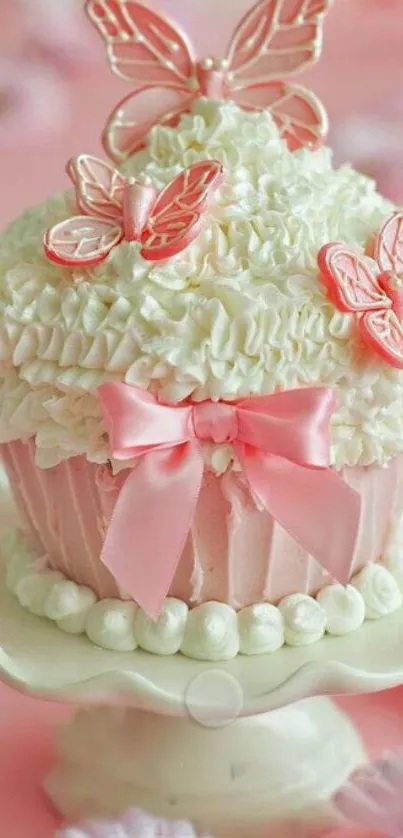 Pink cupcake with butterfly decorations on a pastel background.