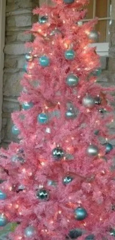 Pink Christmas tree with blue ornaments.