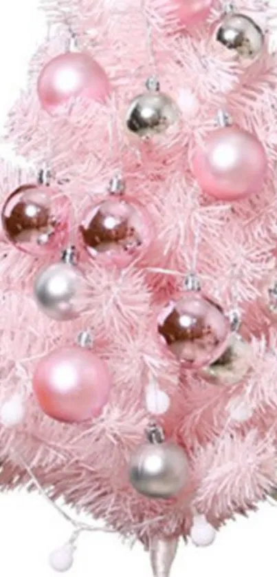 Pink Christmas tree with metallic ornaments.