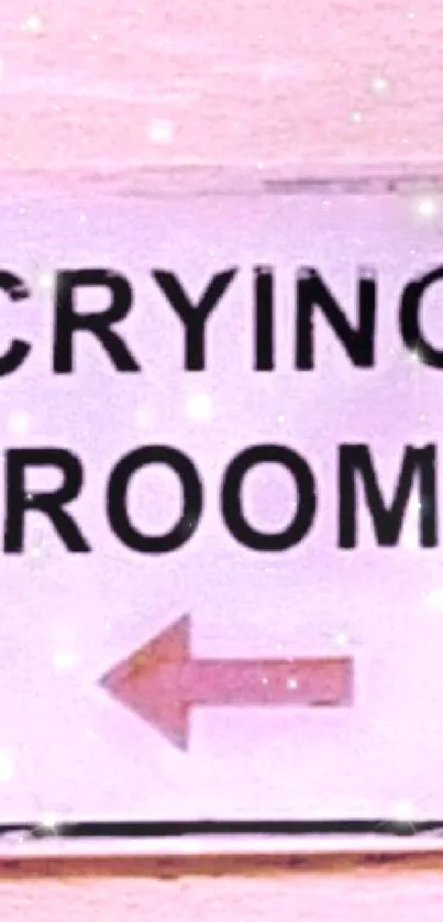 Pink wall with a crying room sign and arrow.