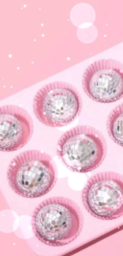 Pink tray with disco ball cupcakes on a pastel background.