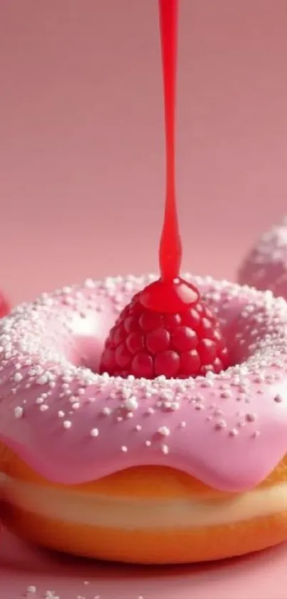 Pink donut topped with raspberry and syrup.