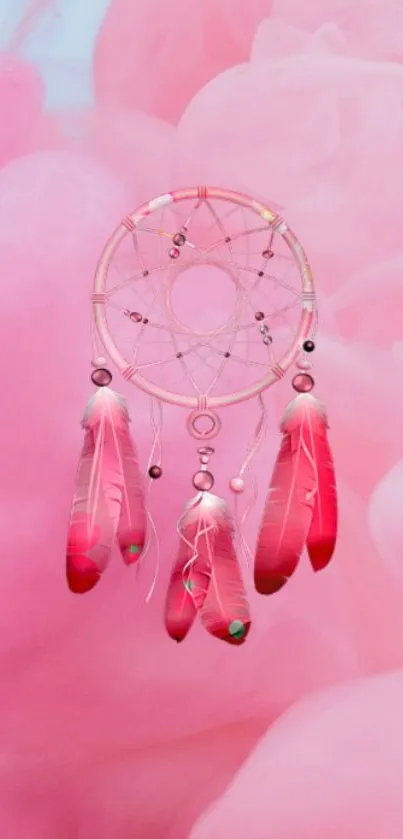 Pink dreamcatcher with feathers on a pastel background.