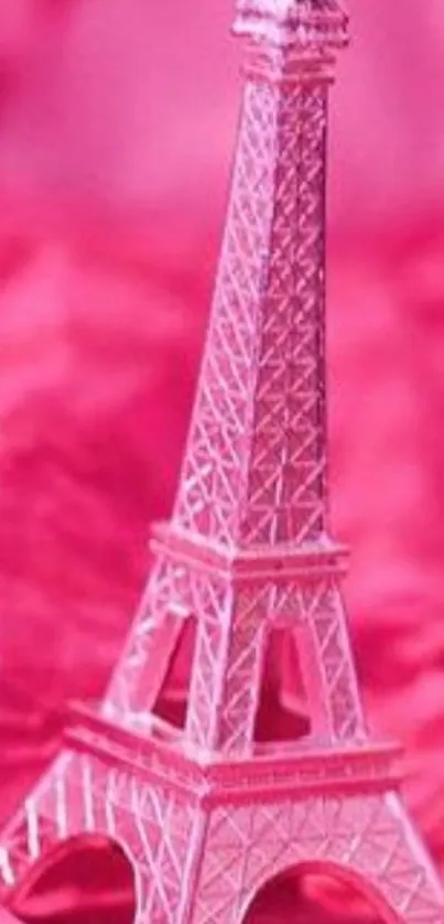 Miniature pink Eiffel Tower on a vibrant background.