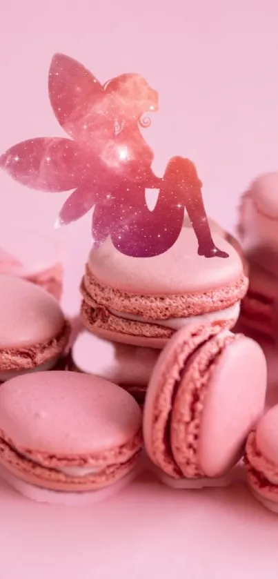 Pink fairy with galaxy wings sitting on pink macarons.