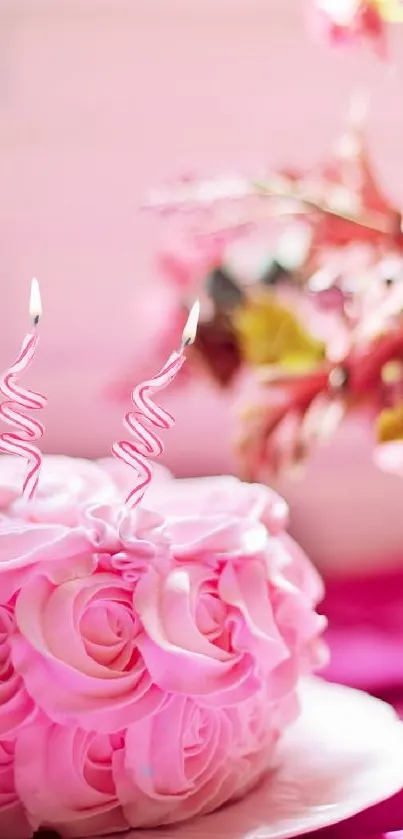 Pink cake with floral decorations and roses against a soft backdrop.